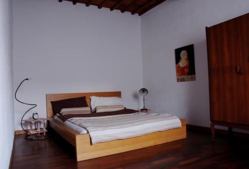 a bedroom with a bed with a wooden headboard at Casa Argo in antico borgo medievale in Borgo a Buggiano