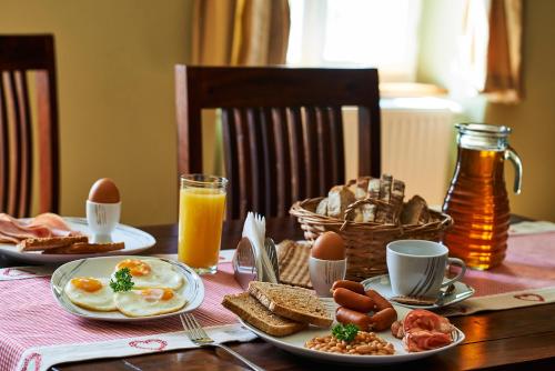 a breakfast table with eggs and bread and toast at Hotel Stará Pekárna s privátním wellness in Liberec