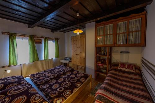 a bedroom with a bed and a book shelf at Csavargó Tanya in Szalafő