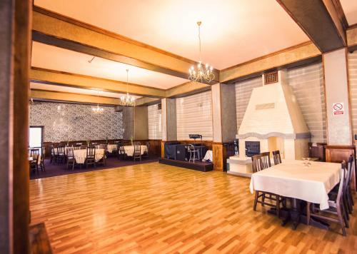 a large room with a table and a fireplace at Hanul Ursilor in Tîrgu Neamţ