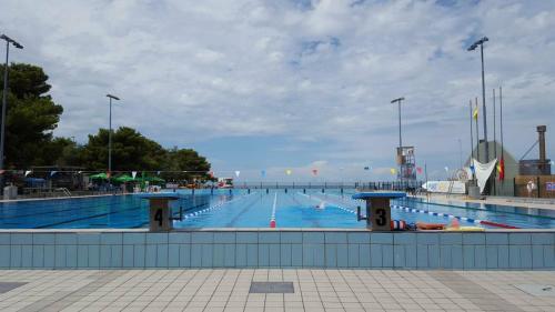 a large swimming pool with a large swimming pool at Apartma Žusterna in Koper