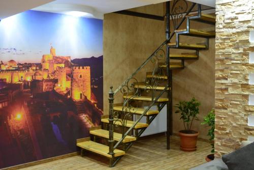 a room with a mural of a castle on the wall at Millennium Rabati in Akhaltsikhe