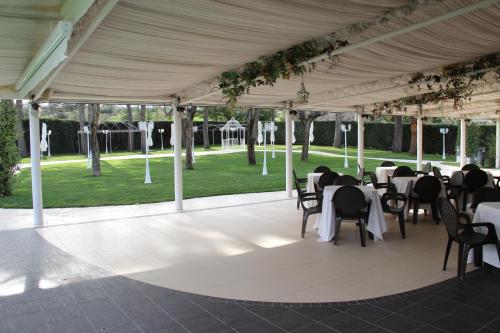 a tent with tables and chairs in a park at Hotel Di Rocco in Loreto Aprutino