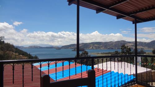 a view from the balcony of a house with a swimming pool at Lago de Tota Las Heliconias in Aquitania