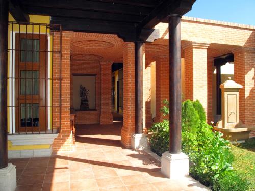 a brick building with a walkway in front of it at Camino Real Antigua in Antigua Guatemala