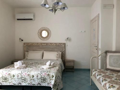 a bedroom with a bed with towels on it at La Casa del Limoneto in Favignana