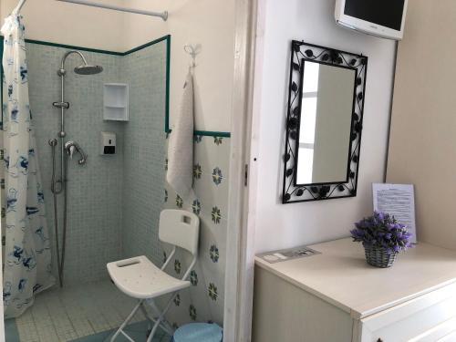 a bathroom with a shower and a sink and a mirror at La Casa del Limoneto in Favignana