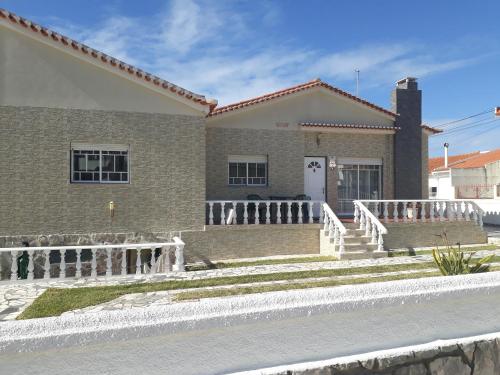 a house with a fence in front of it at Nazaré Villa North Wave in Nazaré