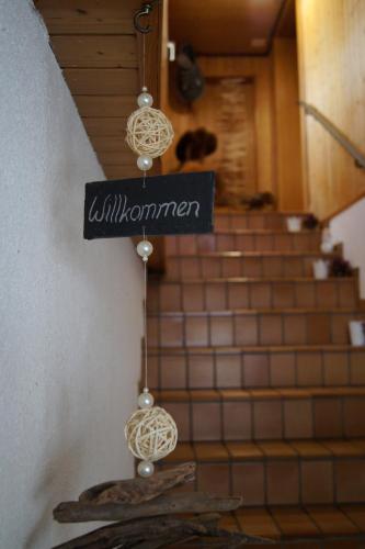 a sign that reads willuminati hanging in front of stairs at Hotel Alpenblick Muotathal in Muotathal