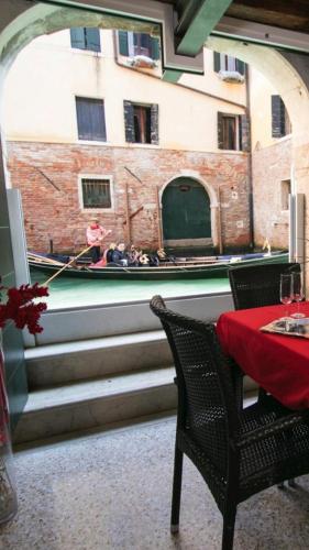 a room with a table and a view of a canal at Casa Marco Polo in Venice