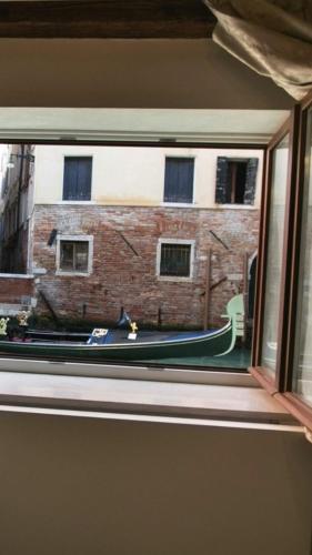 a window with a view of a brick building at Casa Marco Polo in Venice