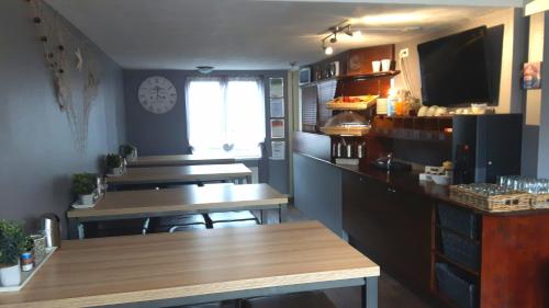 a kitchen with a table and a counter top at Hotel Velsen in IJmuiden