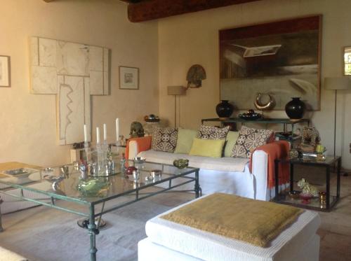 a living room with a couch and a table at Maison d'Hôtes Mas de Barbut in Saint-Laurent-dʼAigouze