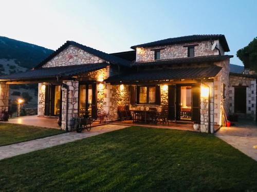 a house with a lawn in front of it at Petrines Villes Avramilias in Avramiliá