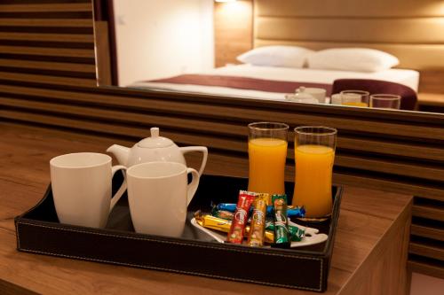 a tray with drinks and snacks on a table in a hotel room at Guest House Pasha in Ulcinj