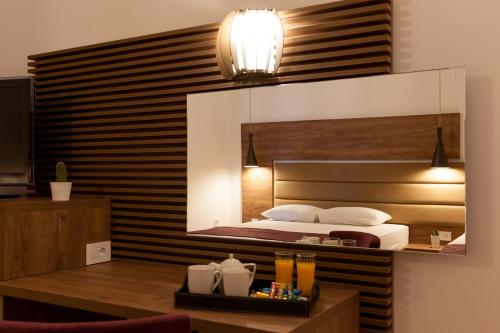 a bedroom with a bed with a large mirror above it at Guest House Pasha in Ulcinj