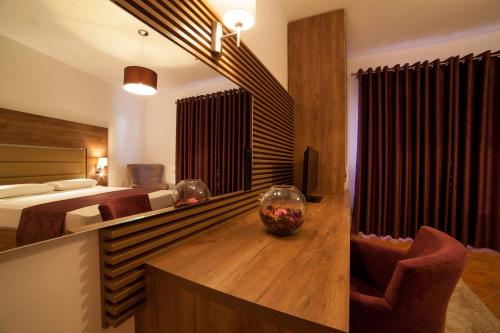 a bedroom with a bed and a desk with a bowl on it at Guest House Pasha in Ulcinj