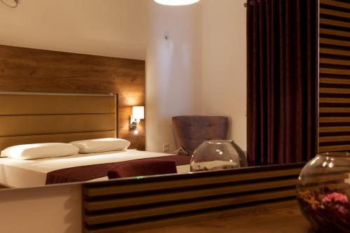 a hotel room with a bed and a mirror at Guest House Pasha in Ulcinj