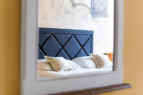 a mirror reflecting a bed with pillows on it at PRIMA Life Spalato in Split