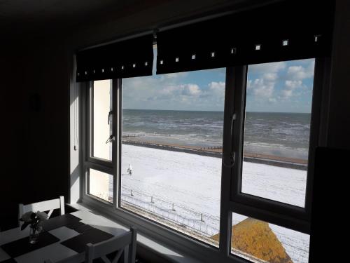 a view of the ocean from a window at Seabreeze in Littlestone-on-Sea