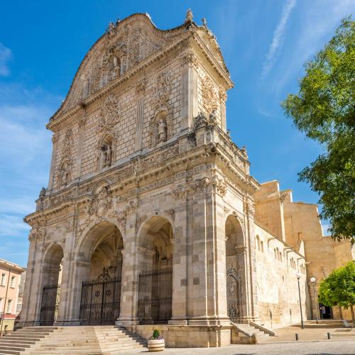 a large stone building with a large tower at Tortuga in Sassari