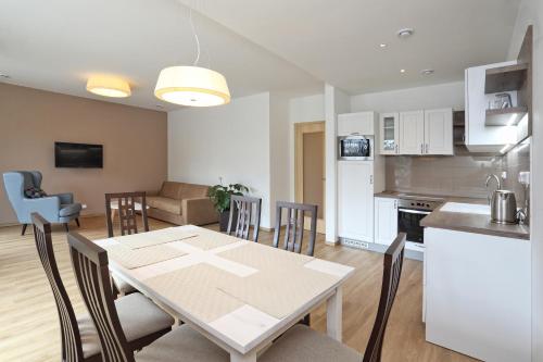 a kitchen and living room with a table and chairs at Apartmány Terasy Café in Liberec