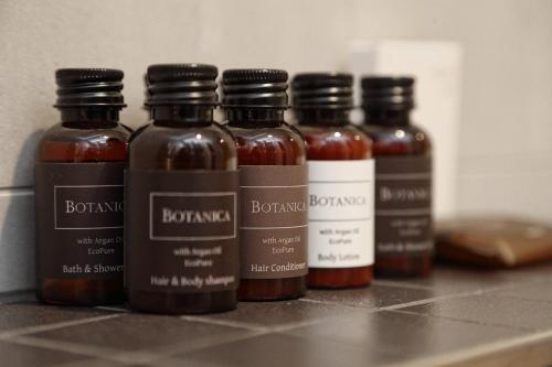 a group of five bottles of barbecue sauce on a counter at Apartmány Terasy Café in Liberec