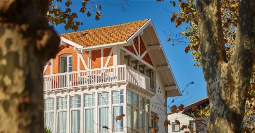 an orange and white house with a balcony at Hotel Atalaya- FREE PARKING GRATUITO in Mundaka