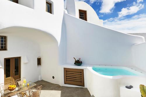 a white house with a swimming pool at The Small Architect's House in Pyrgos