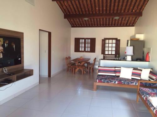 a living room with a couch and a table at Casa em São Miguel dos Milagres - 700m do mar in São Miguel dos Milagres