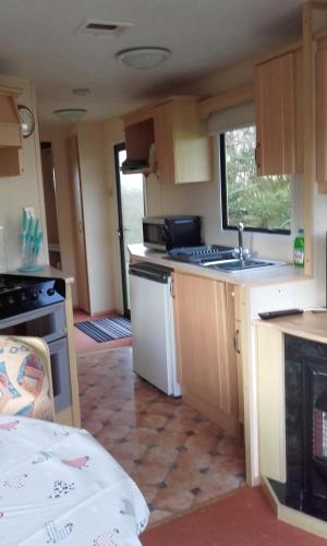 a small kitchen with a sink and a stove at Blackmoor Farm in Narberth