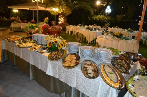 a table with plates of food on it at La Villa dei Gourmets - Struttura Sanificata in Foggia