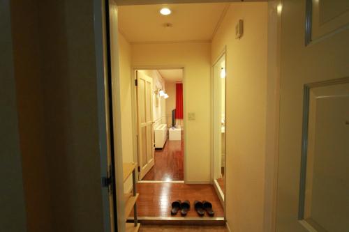 a hallway with shoes on the floor next to a door at Hotel JIN (Adult Only) in Hamamatsu