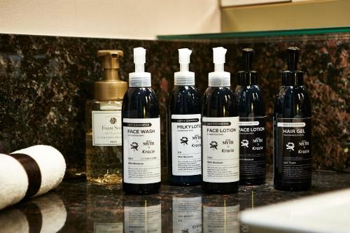 a group of four bottles of wine sitting on a counter at HOTEL MYTH M -ホテル マイス エム- Adult Only in Sennan