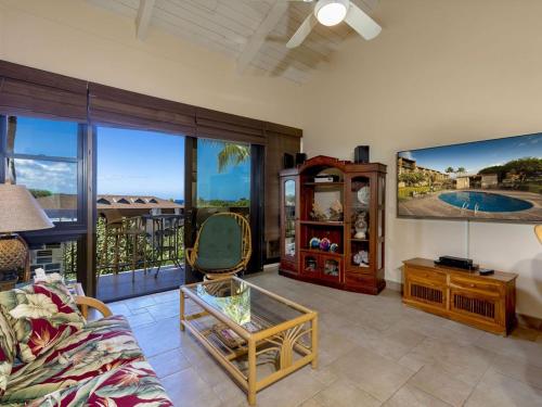 a living room with a couch and large windows at Amazing Kihei Kai Nani - Maui Vista One Bedroom Condos in Kihei