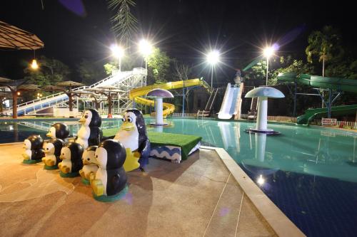 a swimming pool at a resort at night at Nonghan Grand Hotel and Resort in Nong Han