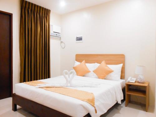 Postel nebo postele na pokoji v ubytování Rublin Hotel Cebu
