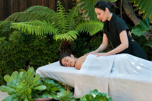 a woman is laying on a massage bed with a woman at Paradise Point Resort & Spa in San Diego