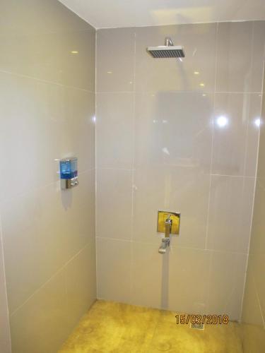 a shower stall in a bathroom with a shower at Cabilao Sunset Dive & Beach Resort in Loon