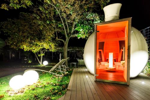 a small house with an open door on a deck at Hotel Villa Groff in Ora/Auer