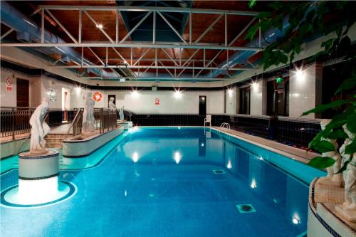 a large swimming pool in a large building at Gold Coast Resort Dungarvan in Dungarvan