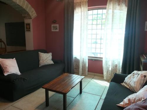 a living room with a couch and a coffee table at La Corte di Nonno in Frascati