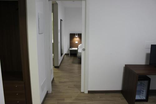 a hallway with a hallway leading to a room at Hotel Bocciolo in Orta San Giulio