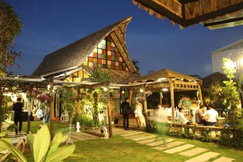 a group of people standing outside of a building at night at The Loft Resort Bangkok in Bangkok