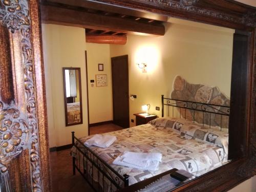 1 dormitorio con 1 cama en un espejo en Bio Agriturismo Olivastrella, en San Venanzo