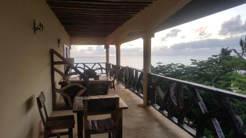 a balcony of a house with a view of the ocean at White Sands in Paje