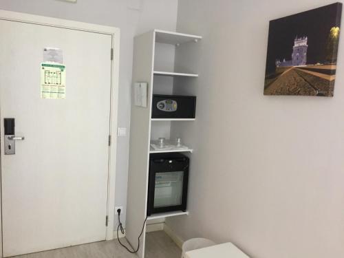 a white refrigerator in a small room at Golden Tram 242 Suites & Hostel in Lisbon