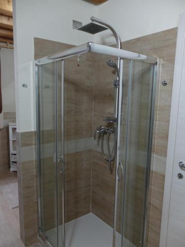 a shower with a glass door in a bathroom at B&B Eldorado in Sommacampagna