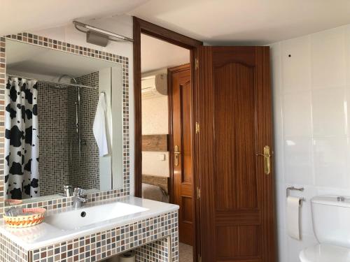 a bathroom with a sink and a mirror at El Colorín in Los Molinos