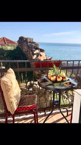 a table with a bowl of fruit on a balcony at Apartments Zuto in Ulcinj
